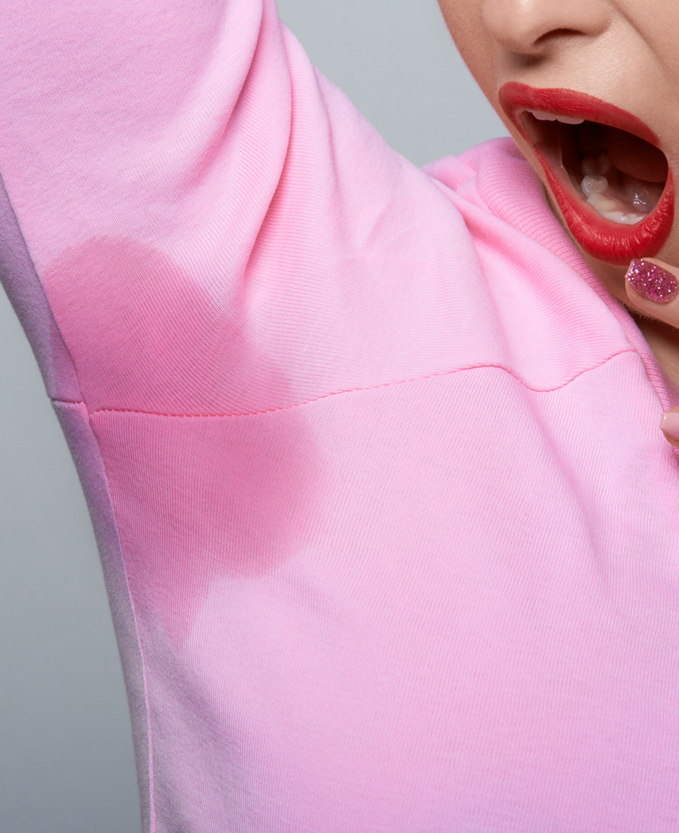 Young-woman-in-pink-casual-blouse-with-hyperhidrosis-and-needing-Botox