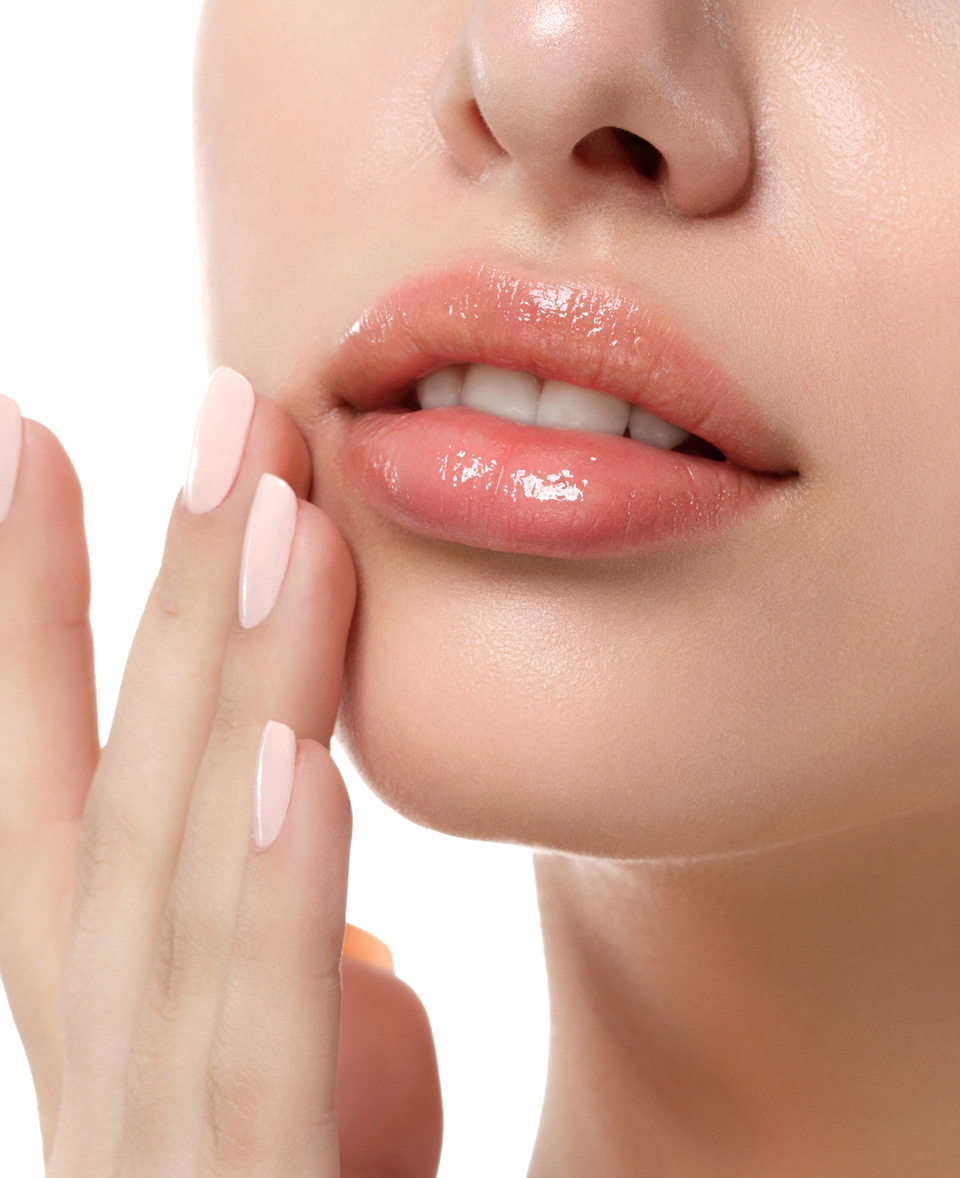 Woman-touching-her-lips,-showing-results-of-dermal-filler-injections