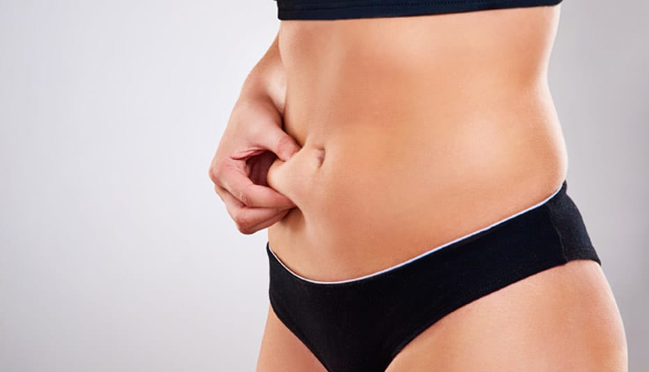 woman-pinching-her-abdomen-before-tummy-tuck
