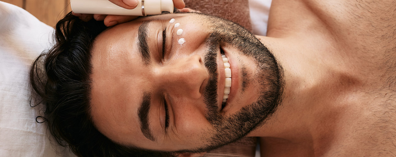 smiling-man-receiving-facial-treatment