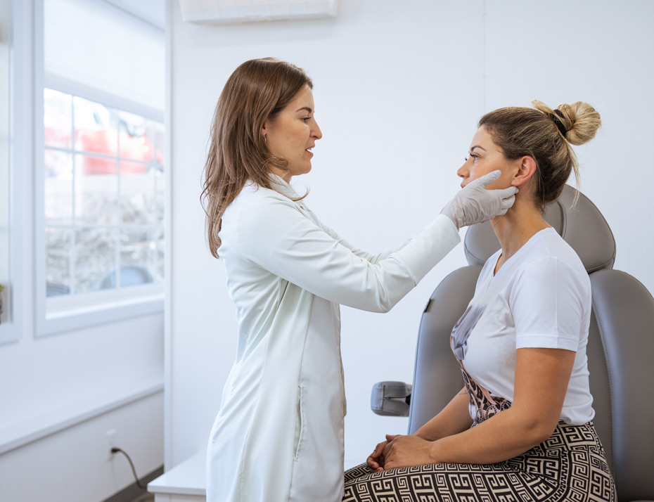 Female-dermatologist-performing-a-procedure-on-a-client