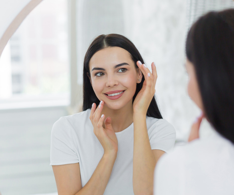 Smiling-middle-aged-woman-touching-smooth-skin