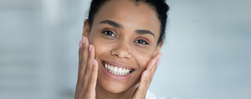 woman-holding-sides-of-her-cheeks-and-smiling